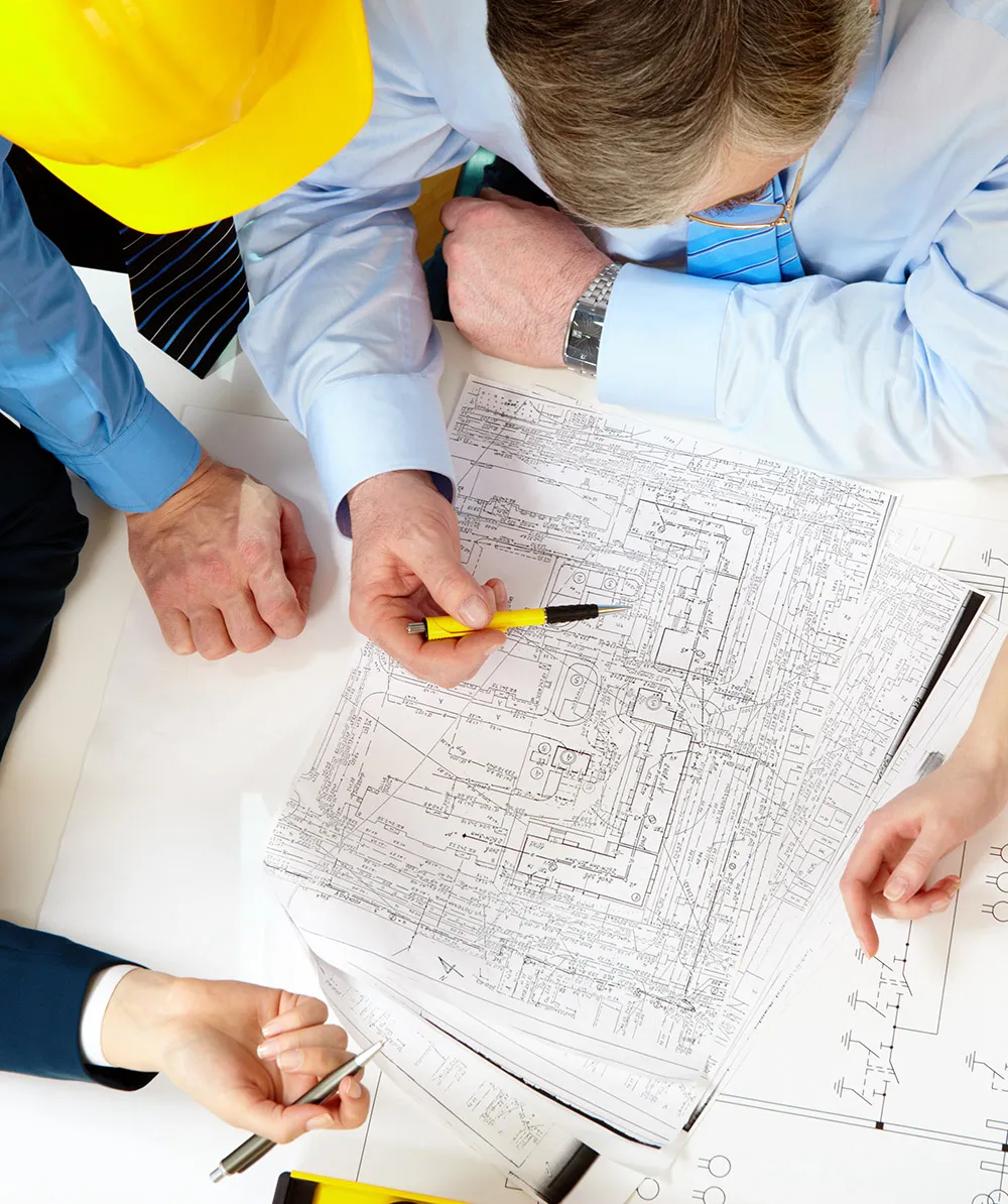 Above view of four architects sitting at the table and discussing design project - Estimating Consulting Services